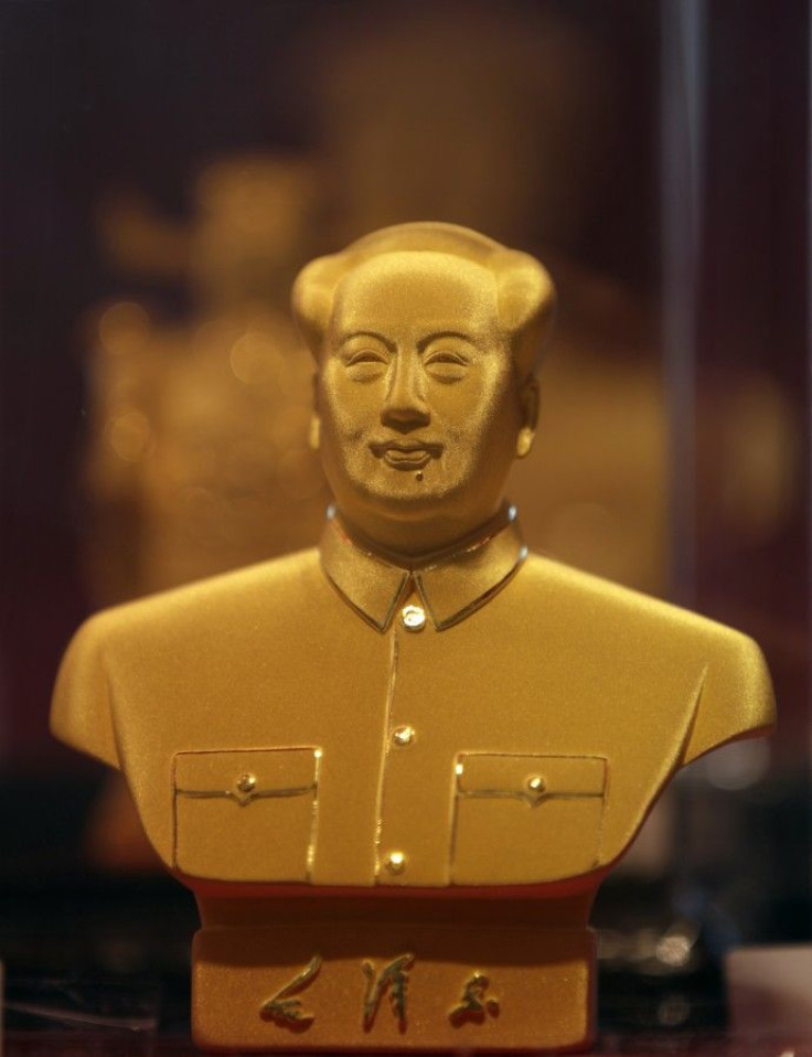 A golden statue of the late Chairman Mao Zedong is seen on display in a glass case at Caibai Ornaments store in Beijing