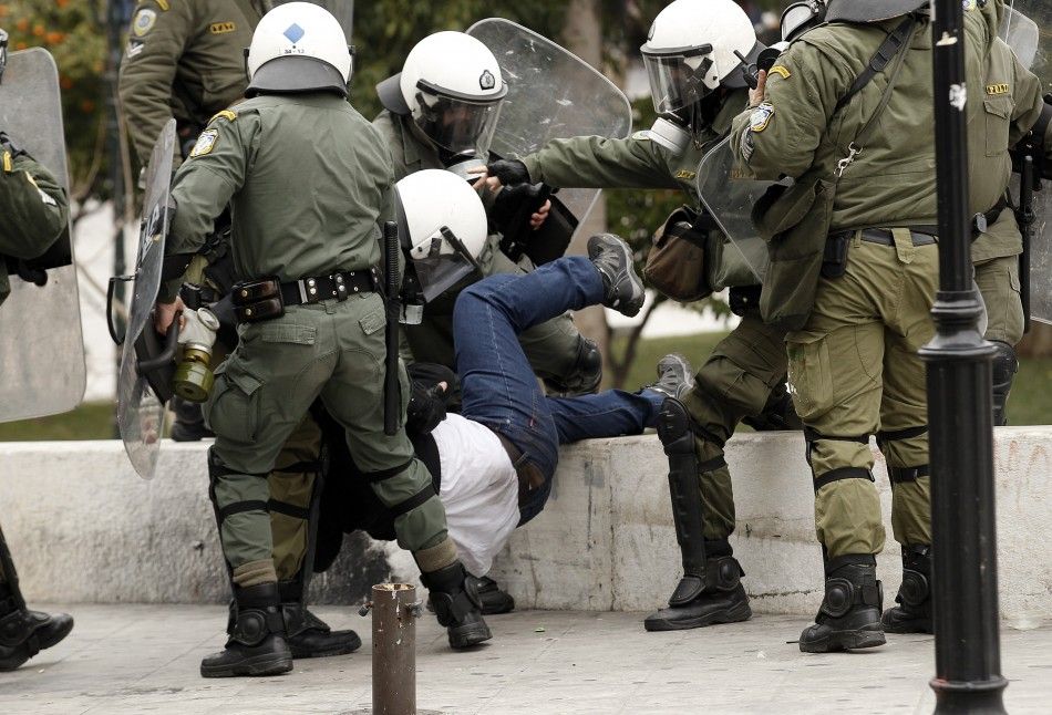 Police drag off a protester during demonstrations in Athens Friday