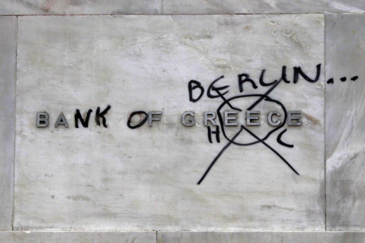 A &#039;Bank of Greece&#039; sign, outside the institution, defiled by protesters Friday