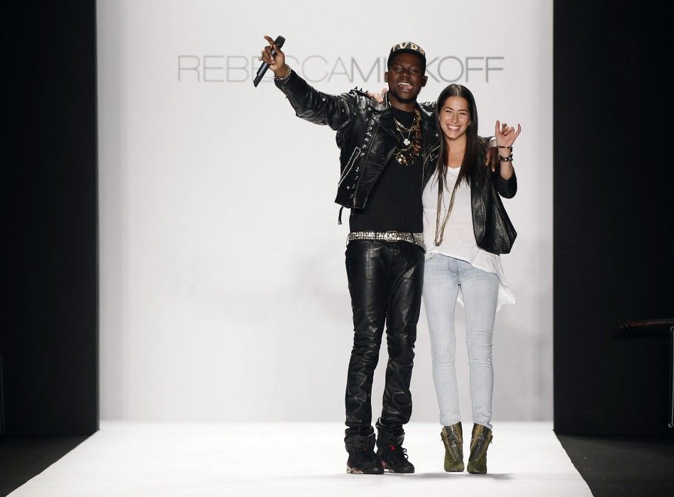 Designer Rebecca Minkoff smiles and waves with a musician after presenting her FallWinter 2012 collection during New York Fashion Week February 10, 2012.