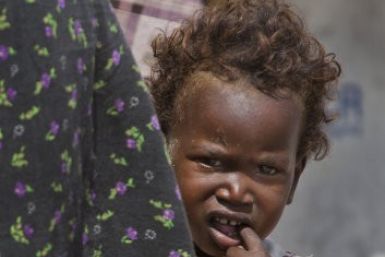 Nasteho Hassan Mohyadin, 3, looks out from behind part of her small makeshift tent in a camp for those displaced by last year&#039;s famine or by conflict, in Mogadishu, Somalia.