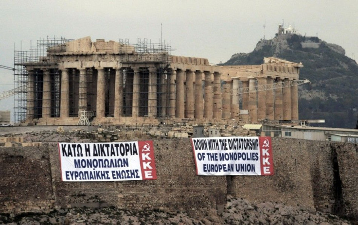 Two anti-austerity banners, placed by activists of the Greek Communist party, are displayed on a hill at the Acropolis in Athens February 11, 2012.