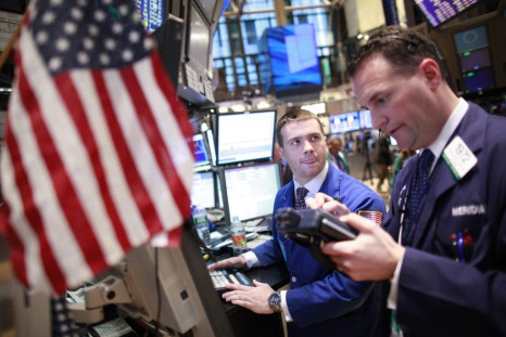 Specialist trader Frank Masiello, left, takes an order from trader Jonathon Corpina on the floor of the New York Stock Exchange on Friday. Feb. 10, 2012