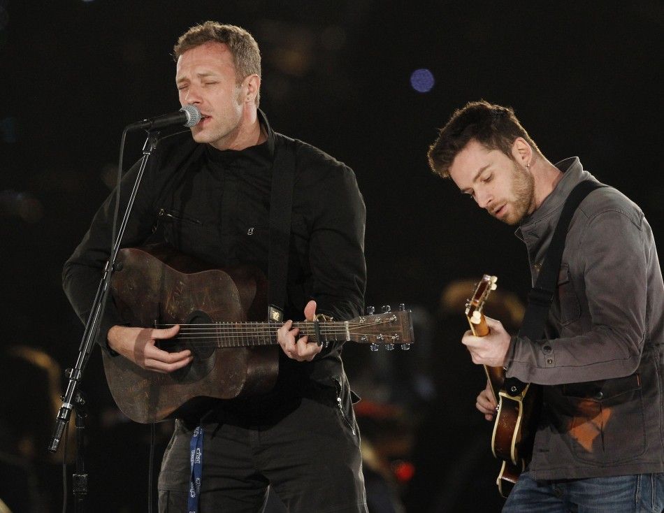 Chris Martin L and Guy Berryman of British band Coldplay perform quotWe Can Work It Outquot during the 2012 MusiCares Person of the Year tribute honoring Paul McCartney in Los Angeles, California