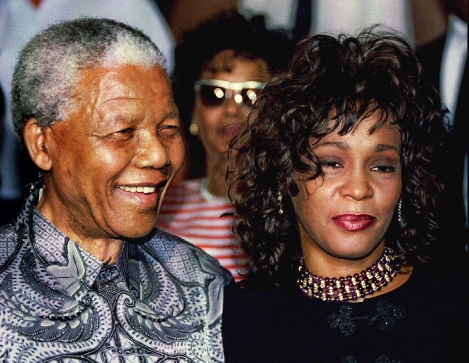 South African President Nelson Mandela and American pop star Whitney Houston smile for photographers.. 