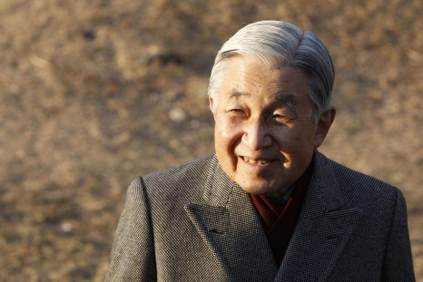 Japan's Emperor Akihito smiles as he talks with residents during a stroll near his imperial villa where he and his wife are staying in Hayama town, south of Tokyo February 2, 2012.