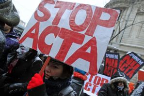 A demonstrator braving freezing temperatures and snow, holds an anti-ACTA (Anti-Counterfeiting Trade Agreement) banner during a protest in Bucharest, February 11, 2012.