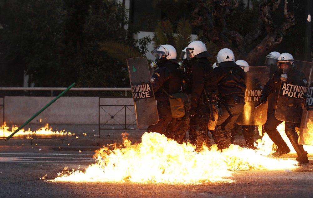 Greece A gasoline bomb thrown by protesters explodes over riot-control officers