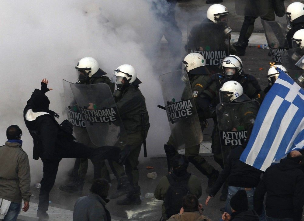 Greece A protester kicks a police officer039s shield during Sunday039s anti-austerity demonstrations.