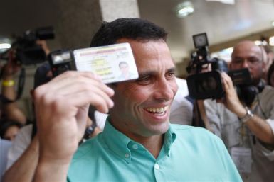 Opposition presidential candidate and Miranda state Governor Henrique Capriles smiles as he arrives to cast his vote at a polling station in Caracas