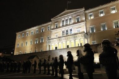 Riot police stand guard in front of the parliament during a protest against austerity measures in Athens