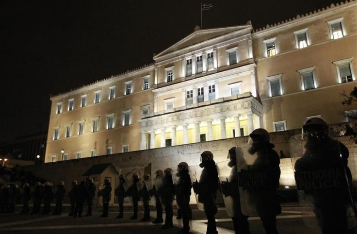 Riot police stand guard in front of the parliament during a protest against austerity measures in Athens