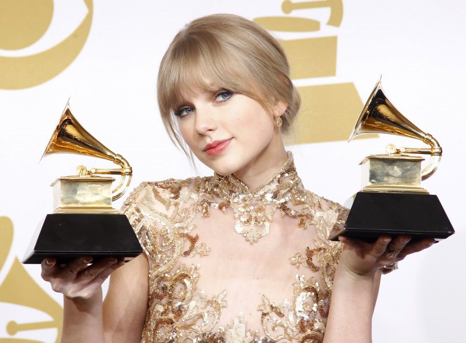 Singer Taylor Swift holds her Grammys for Best Country Song and Best Country Solo Performance quotMeanquot at the 54th annual Grammy Awards in Los Angeles, California
