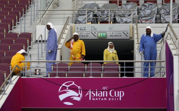 A group of workers clean Khalifa stadium in Doha