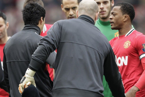 Partice Evra reacts to Luis Suarez&#039;s snub in the handshake line on Saturday.
