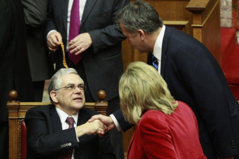 Greek PM Papademos receives congratulations as Greek lawmakers approved a new austerity deal in Athens