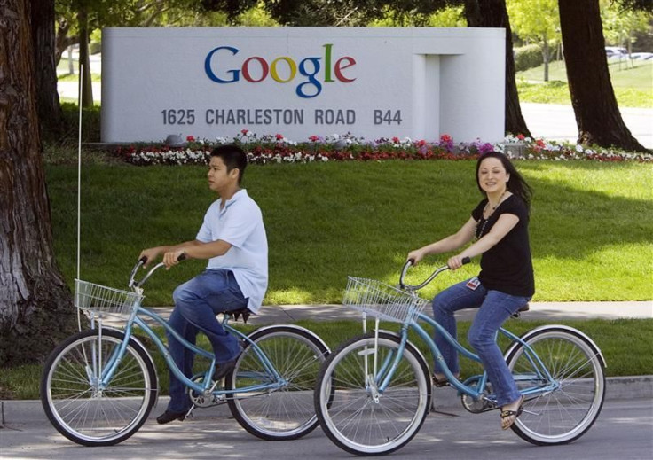 People ride their bikes past Google Inc. headquarters in Mountain View